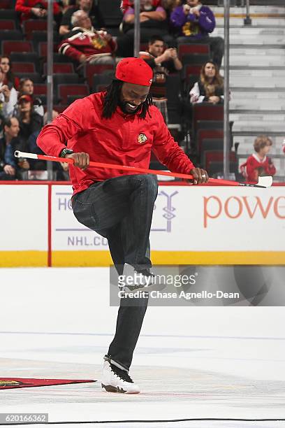 Charles "Peanut" Tillman, former NFL cornerback, reacts after shooting the puck in between periods of the game between the Chicago Blackhawks and the...