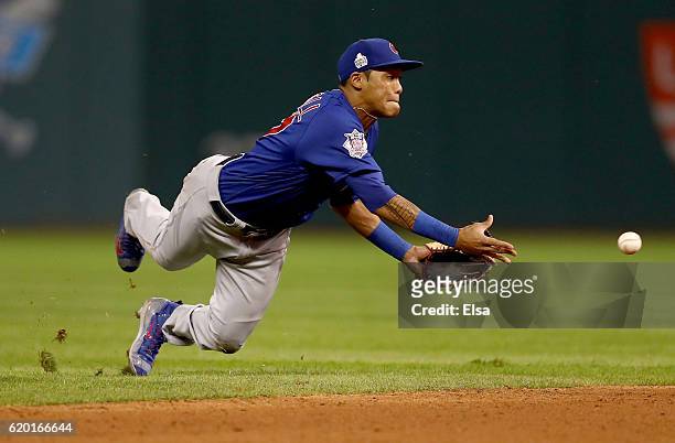 Addison Russell of the Chicago Cubs throws the ball to Javier Baez , to force out Lonnie Chisenhall of the Cleveland Indians at second base during...