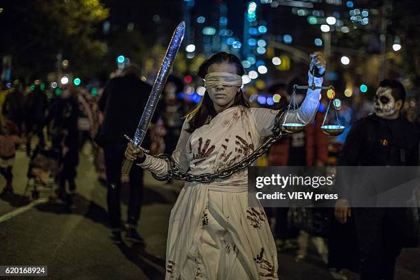 People dressed in Halloween costume take part in Halloween celebrations held within 43rd annual Village Halloween parade October 31, 2016 in New York.