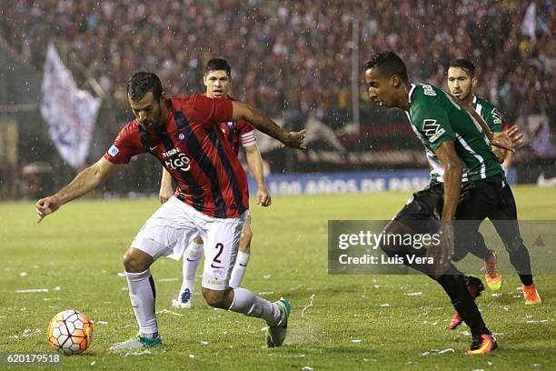 Raul Caceres of Cerro Porteño drives the ball while followed by John Mosquera of Atletico Nacional during a first leg match between Cerro Porteño and...