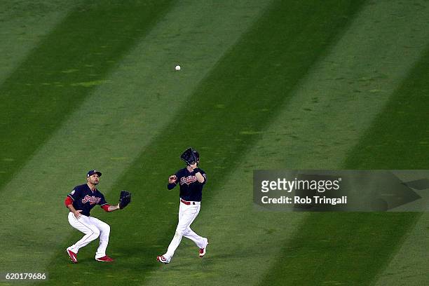 Coco Crisp and Lonnie Chisenhall of the Cleveland Indians field a ball in the top of the sixth inning of Game 6 of the 2016 World Series between the...