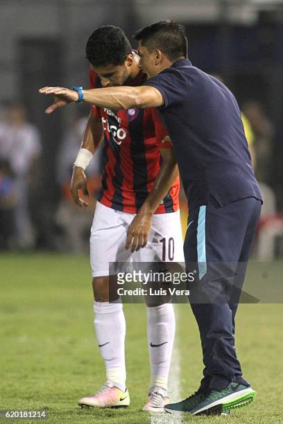 Gustavo Florentin coach of Cerro Porteño gives instructions to his player Cecilio Dominguez during a first leg match between Cerro Porteño and...
