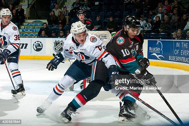 Nolan Kneen of the Kamloops Blazers stick checks Nick Merkley of the Kelowna Rockets as he skates with the puck during third period on November 1,...