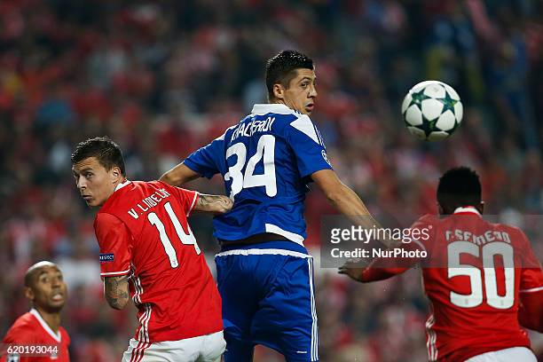 Dynamo Kyiv's defender Evgen Khacheridi heads for the ball with Benfica's defender Victor Nilsson-Lindelof and Benfica's defender Nelson Semedo...