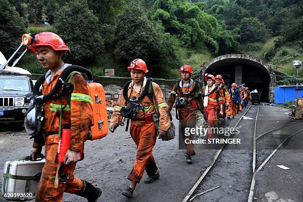 This photo taken on November 1, 2016 shows rescuers exiting Jinshangou Coal Mine in Yongchuan District of Chongqing. All 33 miners missing after a...