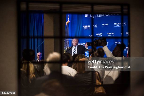 Republican presidential candidate Donald Trump, seen reflected in a mirror, speaks during a campaign event at the DoubleTree by Hilton Philadelphia...