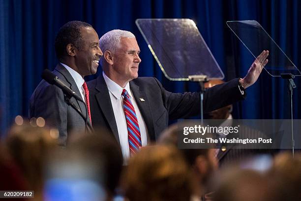Republican vice presidential candidate, Indiana Gov. Mike Pence and Dr. Ben Carson wave after speaking during a campaign event at the DoubleTree by...