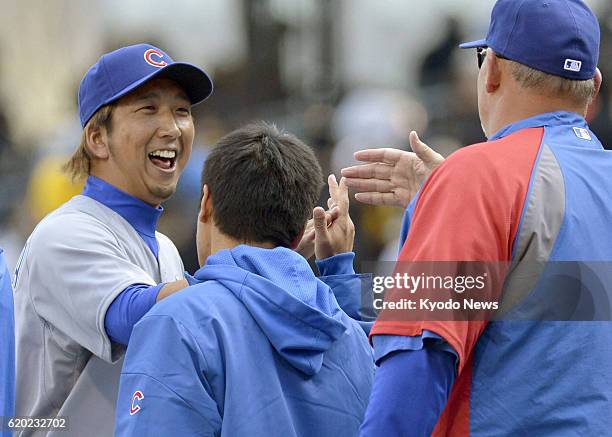 United States - Kyuji Fujikawa of the Chicago Cubs celebrates with the team's pitching coach Chris Bosio after getting a save against the Pittsburgh...