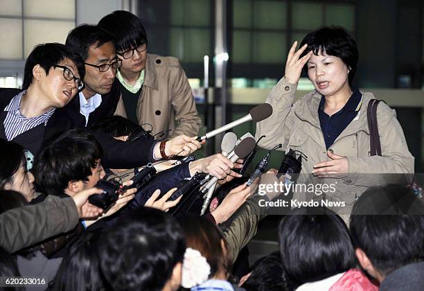 South Korea - A South Korean woman answers reporters' questions at the inter-Korean transit office in Paju, South Korea, on April 3 after returning...