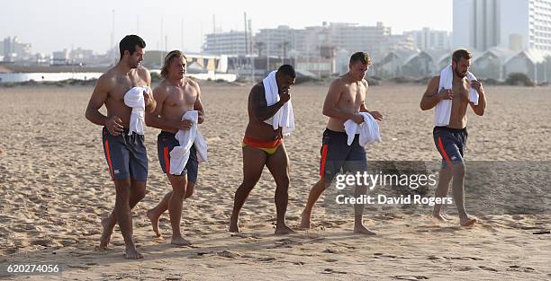 Josh Beaumont, Tommy Taylor, Kyle Sinckler, Mike Haley and Chris Robshaw walk down the beach before having a swim in the Atlantic Ocean during the...