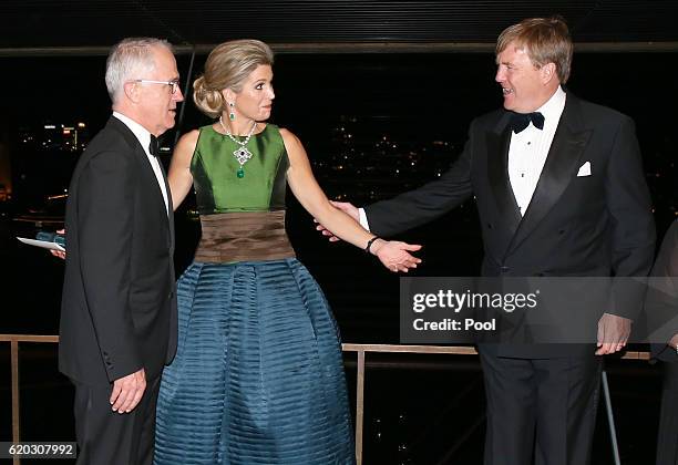 Queen Maxima of the Netherlands gestures to her husband King Willem-Alexander as they arrange positions for a group photograph as Australian Prime...