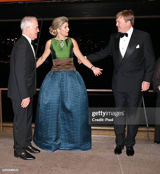 Queen Maxima of the Netherlands gestures to her husband King Willem-Alexander as they arrange positions for a group photograph as Australian Prime...