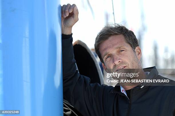 French skipper Eric Bellion poses aboard his class Imoca monohull "Comme un seul homme" on November 2, 2016 in Les Sables-d'Olonne, western France,...