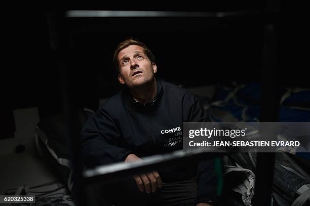 French skipper Eric Bellion poses aboard his class Imoca monohull "Comme un seul homme" on November 2, 2016 in Les Sables-d'Olonne, western France,...