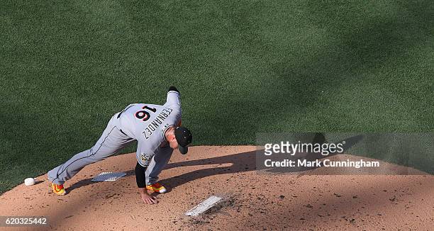 National League All-Star Jose Fernandez of the Miami Marlins leans down and grabs a handful of dirt off the pitchers mound while pitching during the...