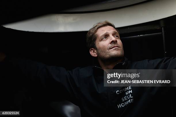 French skipper Eric Bellion poses aboard his class Imoca monohull "Comme un seul homme" on November 2, 2016 in Les Sables-d'Olonne, western France,...