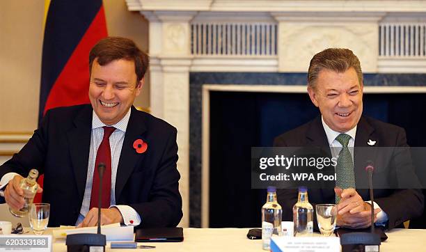 Colombia's President Juan Manuel Santos, right, laughs with Greg Hands, Britain's minister of State for Trade and Investment, during a business...