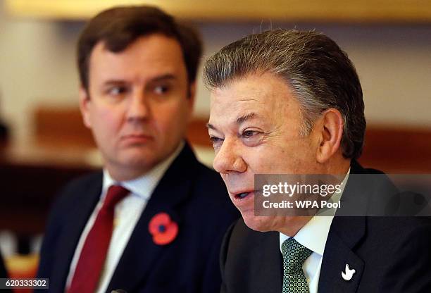 Colombia's President Juan Manuel Santos, right, sits with Greg Hands, Britain's minister of State for Trade and Investment, during a business meeting...