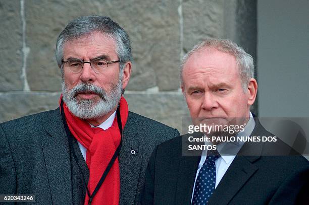 Northern Irish deputy First Minister Martin McGuinness and Sinn Fein leader Gerry Adams address members of the media as they arrive to attend the...