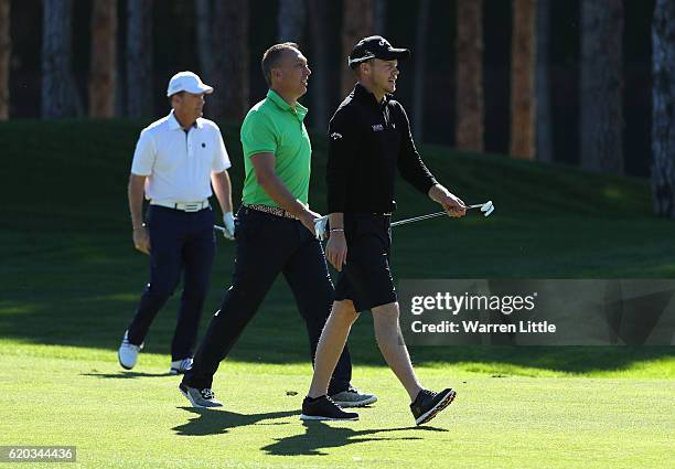 Former England international footballer, David Platt and Danny WIllett of England walk up the first hole during the pro-am event ahead of the Turkish...