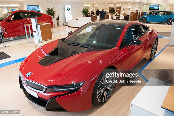 New BMW i8 Edrive hybrid petrol-electric car in red and black sits in a showroom on October 20, 2016 in Southend, United Kingdom.