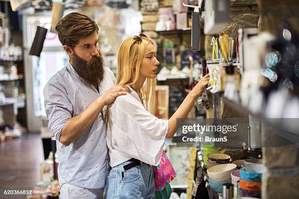 young couple shopping together in a store. - young couple shopping stock pictures, royalty-free photos & images