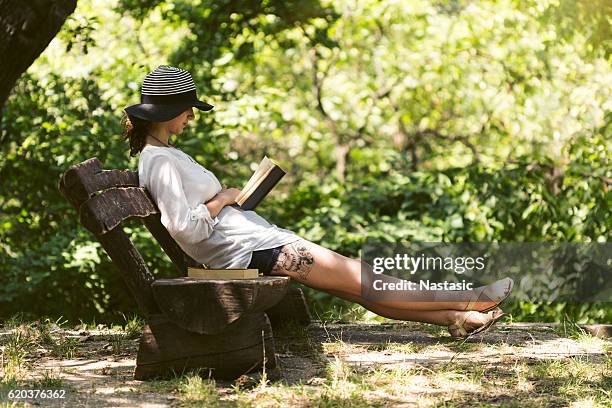 relaxing with book - shade stock pictures, royalty-free photos & images