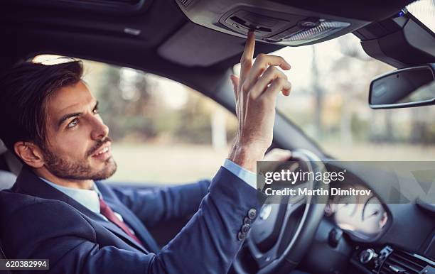 man in car using the car assistance button - sos stock pictures, royalty-free photos & images