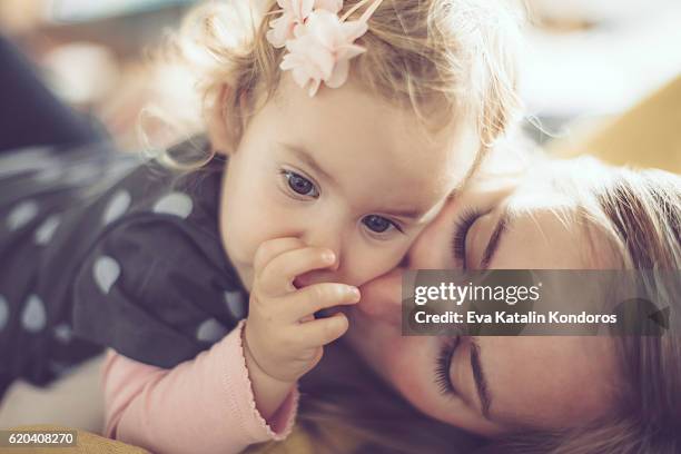 mother and her little daughter at home - thumb sucking stock pictures, royalty-free photos & images