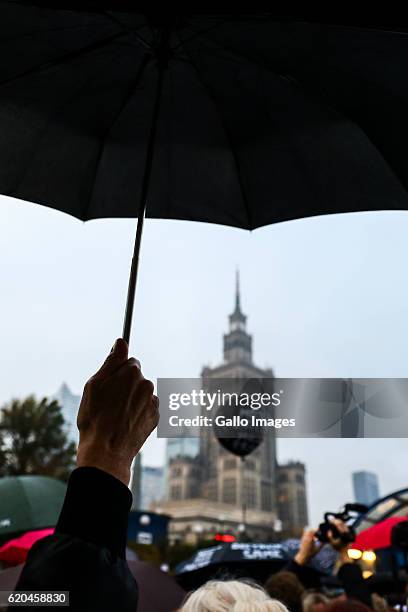 Women with umbrellas participate in the nationwide Womens Strike on October 24, 2016 in the city centre of Warsaw, Poland. The mass action aims to...