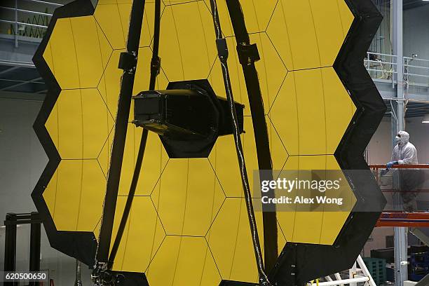 Technician stands next to the James Webb Space Telescope during assembly November 2, 2016 at NASA's Goddard Space Flight Center in Greenbelt,...