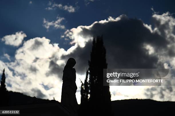 Statue of the Virgin Mary stands in the damaged cemetery of Norcia, on November 2, 2016 three days after a 6.5 magnitude earthquake hit central...