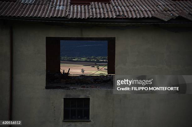 View of the countryside through a window of a collapsed factory in San Pellegrino near Norcia, on November 2, 2016 three days after a 6.5 magnitude...