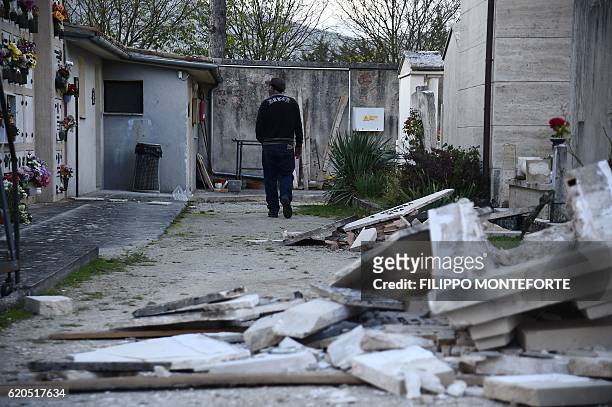 Man walks in the damaged cemetery of Norcia, on November 2, 2016 three days after a 6.5 magnitude earthquake hit central Italy. Some 3,000 farms in...