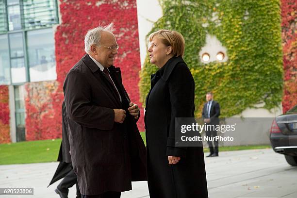 German Chancellor Angela Merkel greets Swiss President Johann Schneider-Ammann upon his arrival at the Chancellery in Berlin on November 2, 2016.