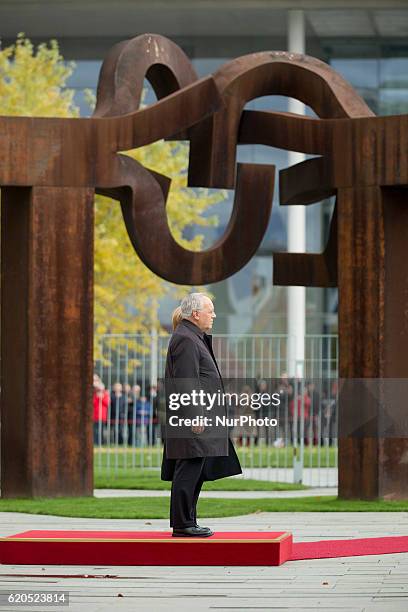 German Chancellor Angela Merkel and Swiss President Johann Schneider-Ammann listen to the national anthems at the Chancellery in Berlin on November...