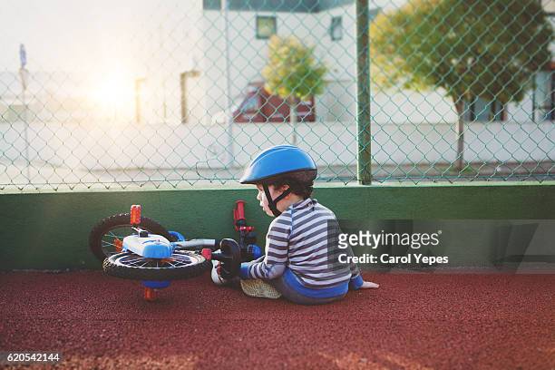 little boy falling off bicycle - falling imagens e fotografias de stock