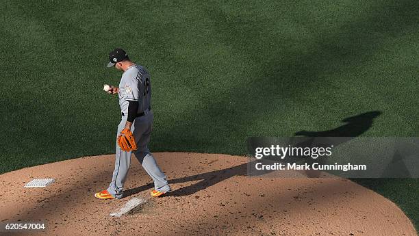 National League All-Star Jose Fernandez of the Miami Marlins looks over a baseball while pitching during the 87th MLB All-Star Game at PETCO Park on...