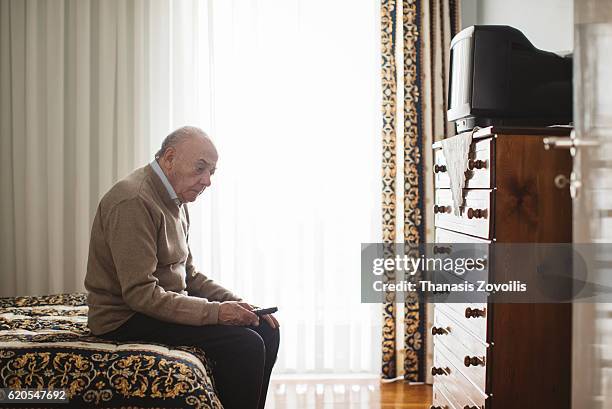 senior man in front of a television - jaded pictures stock pictures, royalty-free photos & images