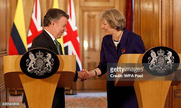 Colombia's President Juan Manuel Santos and Britain's Prime Minister Theresa May shake hands during a press statement at 10 Downing Street on...