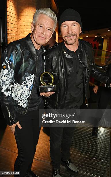 Adam Clayton and The Edge, accepting the Best Live Act award on behalf of U2, attend The Stubhub Q Awards 2016 at The Roundhouse on November 2, 2016...