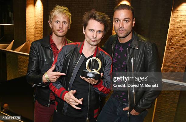 Dominic Howard, Matt Bellamy and Chris Wolstenholme of Muse, winners of the Best Act In The World Today award, pose at The Stubhub Q Awards 2016 at...