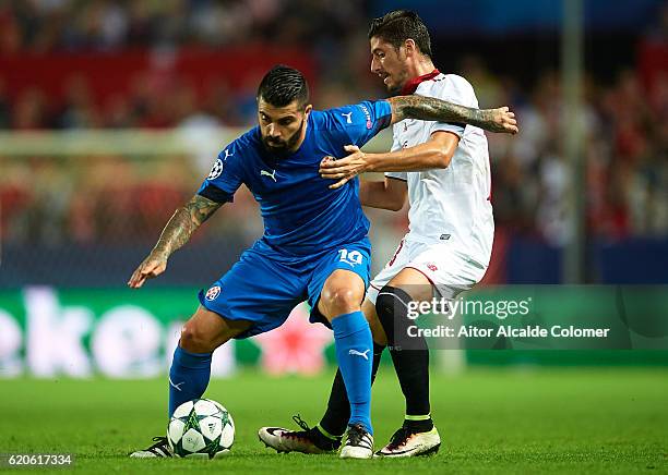 El Arabi Hilal Soudani of GNK Dimano Zagreb competes for the ball with Sergio Escudero of Sevilla FC during the UEFA Champions League match between...