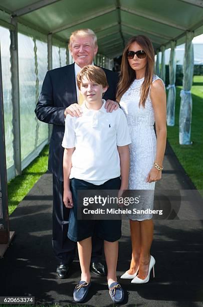 Businessman Donald Trump, son Barron, and wife Melania at the Trump Invitational Grand Prix at Mar-a-Lago, Palm Beach, Florida, January 4, 2015.