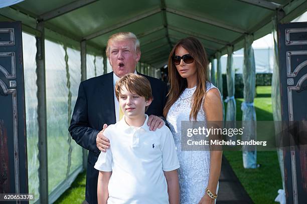 Businessman Donald Trump, son Barron, and wife Melania at the Trump Invitational Grand Prix at Mar-a-Lago, Palm Beach, Florida, January 4, 2015.