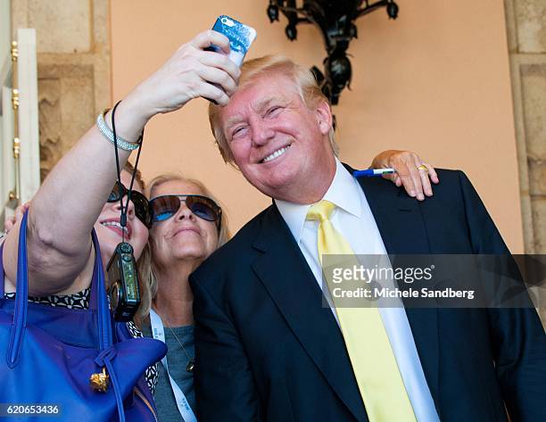 Donald Trump gets his photo taken by an unidentified attendee at the Trump Invitational Grand Prix at Mar-a-Lago, Palm Beach, Florida, January 4,...