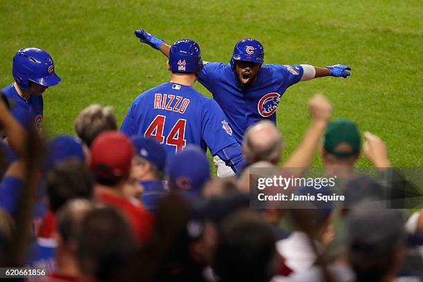 Dexter Fowler of the Chicago Cubs celebrates with Anthony Rizzo after Fowler hits a lead off home run in the first inning against the Cleveland...