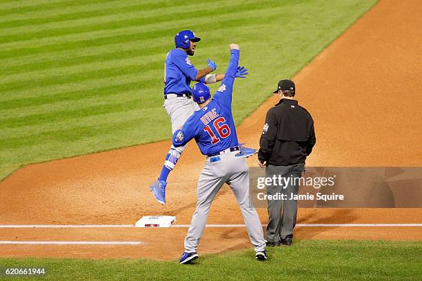 Dexter Fowler of the Chicago Cubs celebrates with first base coach Brandon Hyde after hitting a lead off home run in the first inning against the...