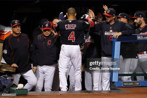 Coco Crisp of the Cleveland Indians celebrates at the dugout after scoring a run on an RBI single hit by Carlos Santana during the third inning...