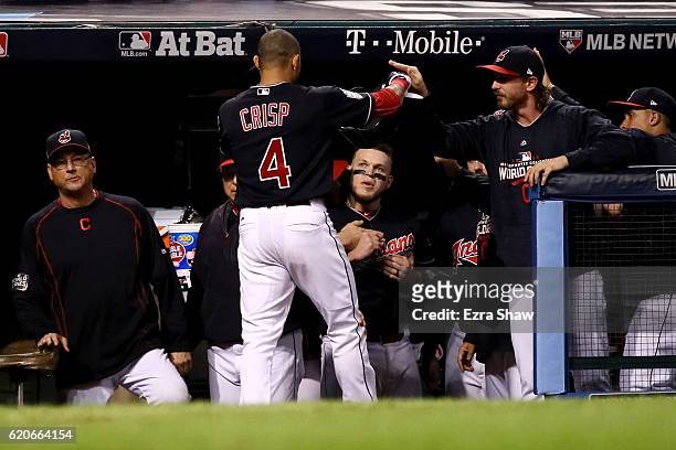 Coco Crisp of the Cleveland Indians celebrates at the dugout after scoring a run on an RBI single hit by Carlos Santana during the third inning...